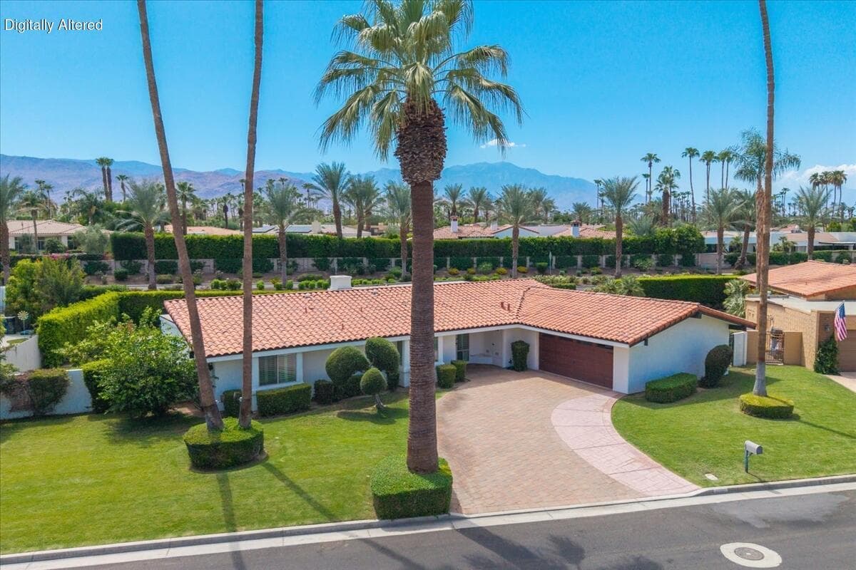 From above, the setting comes into focus - a private, single-story retreat framed by towering palms with the Santa Rosa Mountains rising in the distance. Imagine pulling into your circular drive each evening with that view as your backdrop.
