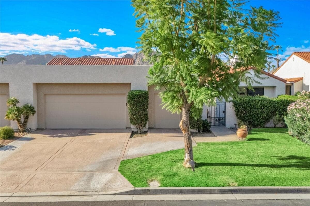Clay tile rooflines, a clean stucco front and the Santa Rosa Mountains behind it. Welcome to easy desert living in Duna La Quinta.