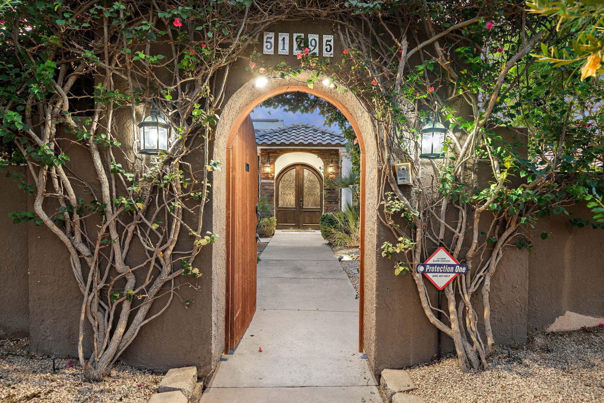 Elegant gate leads to double door entrance