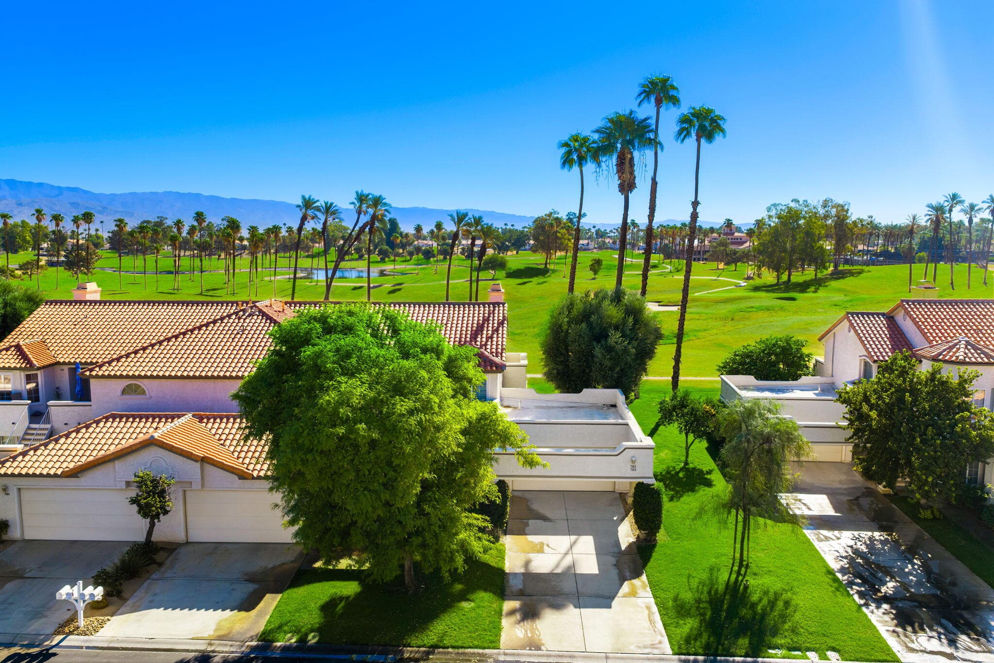 Aerial of front of home. East facing, golf course location. Golf course is currently brown due to seasonal overseeding so has been greened with AI.