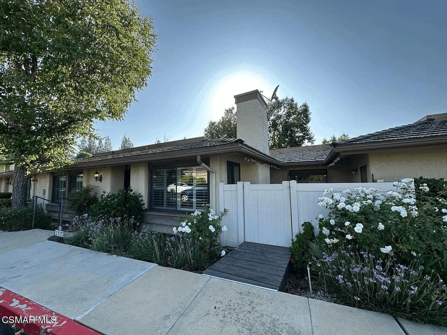 Corner unit with direct access to one car garage across patio.